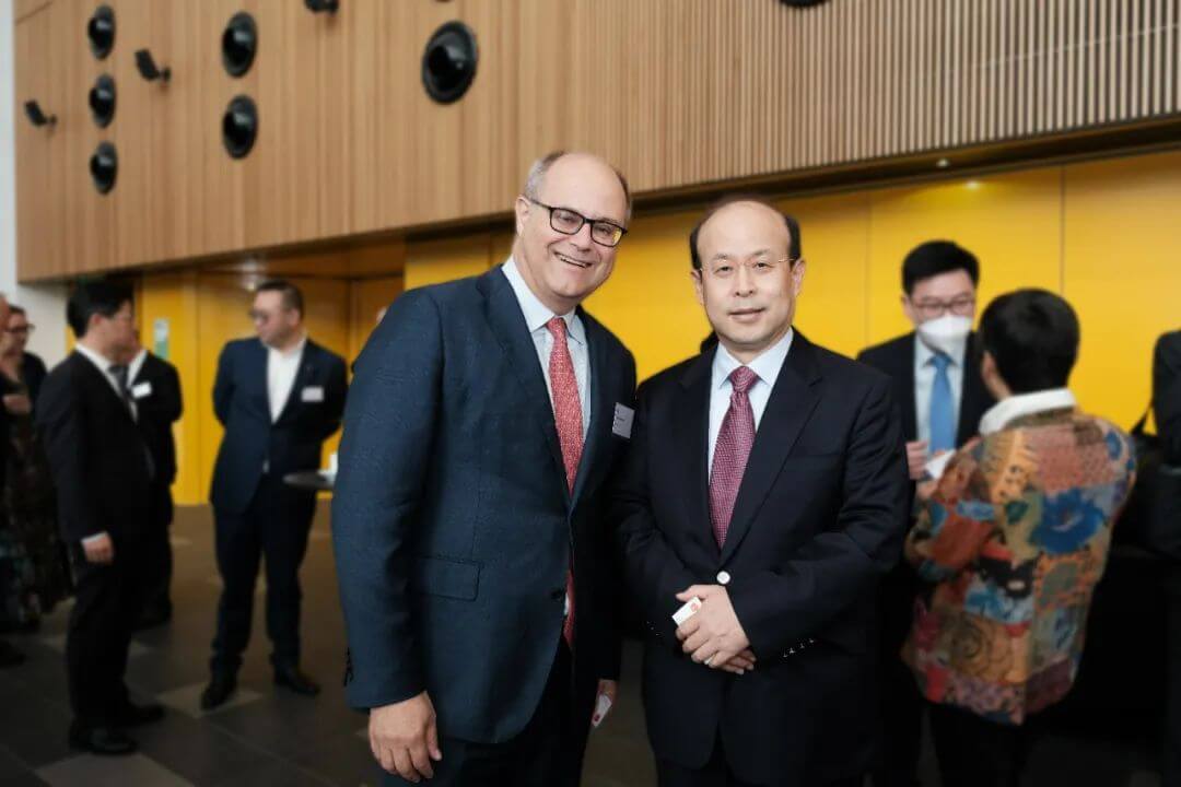 Andrew Martin and male individual smiling