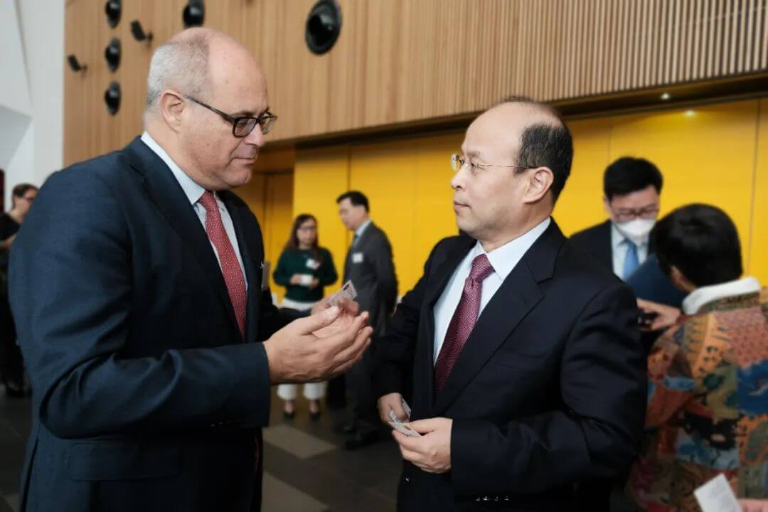 Andrew Martin in discussion with five people in the background